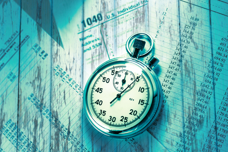Tax form, operating budget and stopwatch in closeupの写真素材