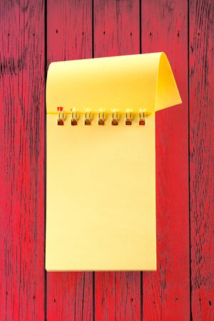 Blank open notebook on the red backgroundの写真素材