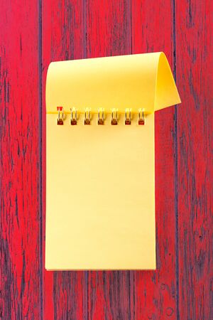 Blank open notebook on the red backgroundの写真素材