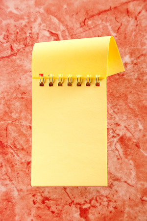 Blank open notebook on the red backgroundの写真素材