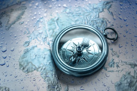 Compass on map background in blue toningの写真素材