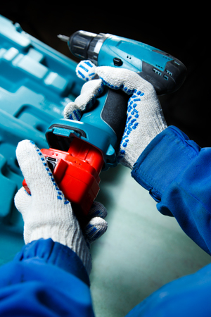 Male hand holding a screwdriver in closeupの写真素材