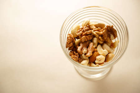 Glass bowl of mixed nuts in closeupの写真素材