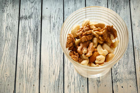 Glass bowl of mixed nuts in closeup