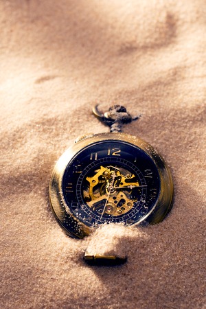 Pocket watch in beach sand light closeupの写真素材