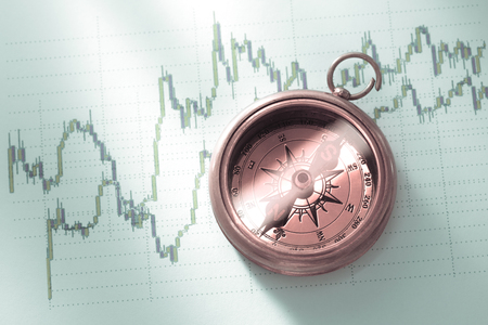 Compass on stock market data chart in closeupの写真素材
