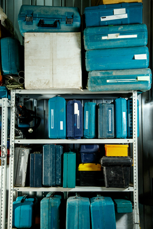 Boxes of tools on shelves in garageの写真素材