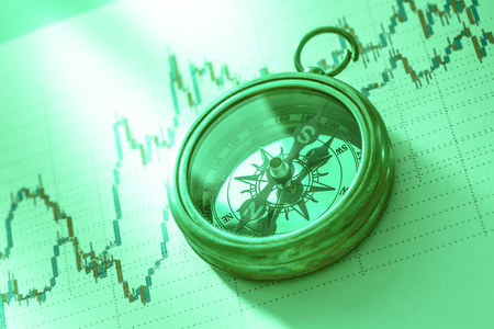 Compass on stock market data chart in closeupの写真素材