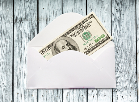 Envelope with one hundred dollar banknote closeupの写真素材