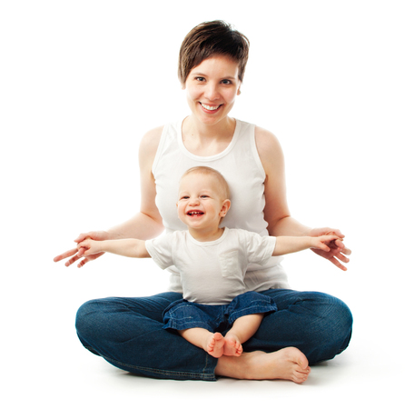 Young mother sitting with her child on white backgroundの写真素材