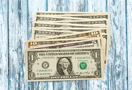 Dollar banknotes of different value on background