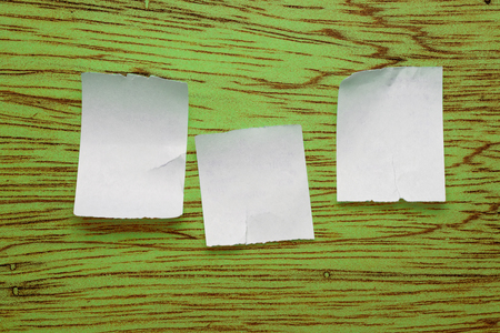 Scraps placed on the green wooden backgroundの写真素材