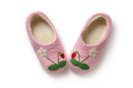 Felt slippers on white background in closeupの写真素材