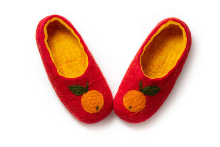 Felt slippers on white background in closeupの写真素材