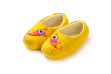 Felt slippers on white background in closeupの写真素材