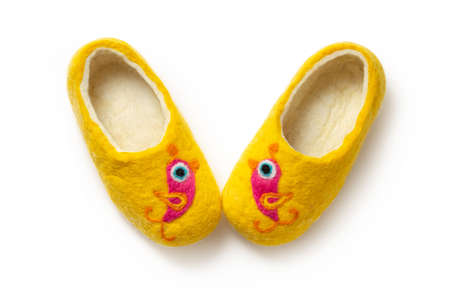 Felt slippers on white background in closeupの写真素材