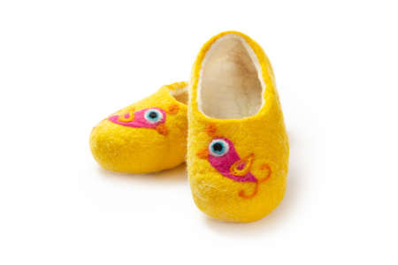 Felt slippers on white background in closeupの写真素材