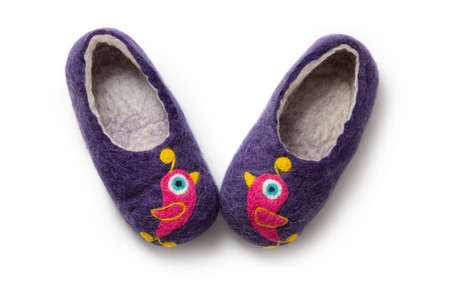 Felt slippers on white background in closeupの写真素材