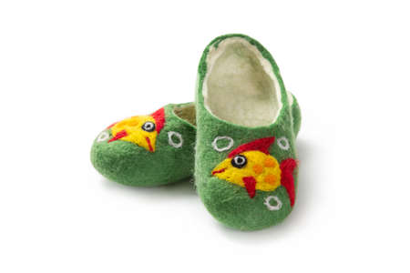 Felt slippers on white background in closeupの写真素材