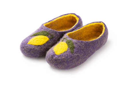 Felt slippers on white background in closeupの写真素材