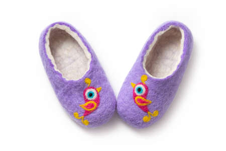 Felt slippers on white background in closeupの写真素材