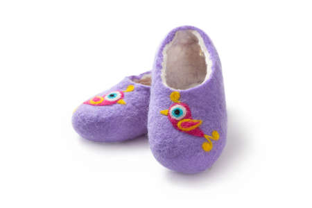 Felt slippers on white background in closeupの写真素材