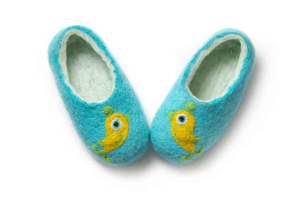 Felt slippers on white background in closeupの写真素材