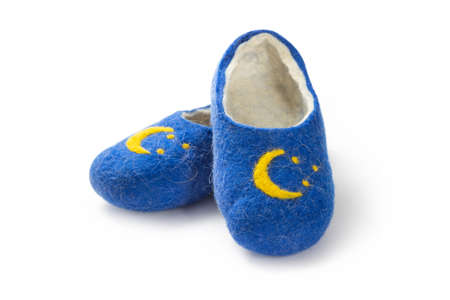 Felt slippers on white background in closeupの写真素材
