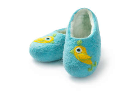 Felt slippers on white background in closeupの写真素材