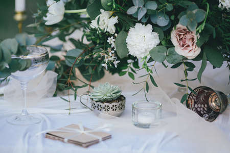 Decoration of the festive table in vintage style. Green and white color. Closeup. The effect of film...