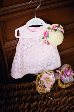Pink dress and straw hat for a little girl. Top viewの写真素材