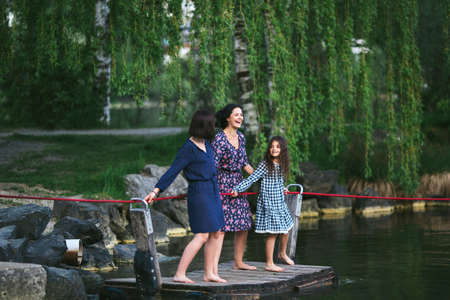Mother with two young daughters are on a raftの写真素材