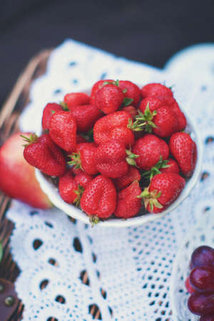Plate with strawberry on a lace tablecloth, the top viewの写真素材