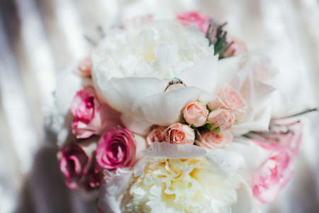 Delicate Bridal bouquet of roses and peonies. Engagement ring with a blue stone in the flower. Concept proposalの写真素材