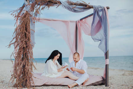 Couple sitting on the beachの写真素材