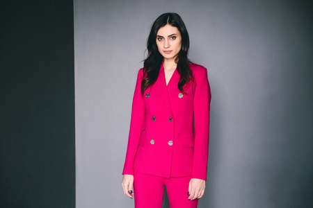 Adorable woman posing in the studio on the wall backgroungの写真素材