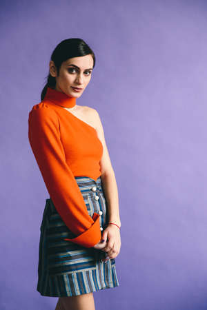 Beautiful young posing woman is in designer clothesの写真素材