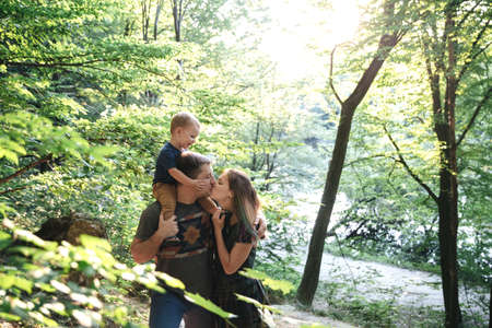 family together on the bank of the riverの写真素材