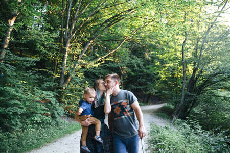 family together on the bank of the riverの写真素材