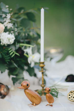 Figurines of wooden ducks on a tableの写真素材