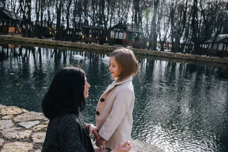 Mom and his daughter are playing and hugging outdoorの写真素材