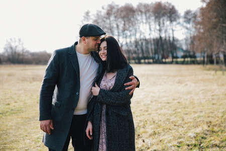 lovely young couple hugging outdoors in autumnの写真素材