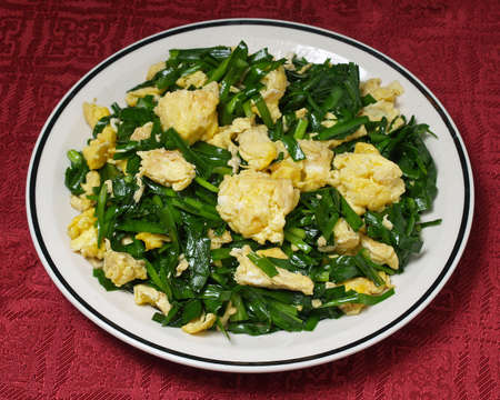 Scrambled eggs with green leekの写真素材