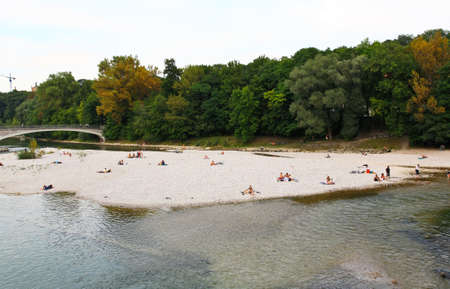 People relaxing at beach of a river in Munichの写真素材