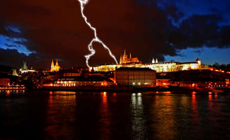 The magnificent Prague Castle at night along the River Vltavaの写真素材