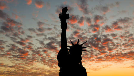 The silhouette of Statue of Liberty under sunrise backgroundの写真素材