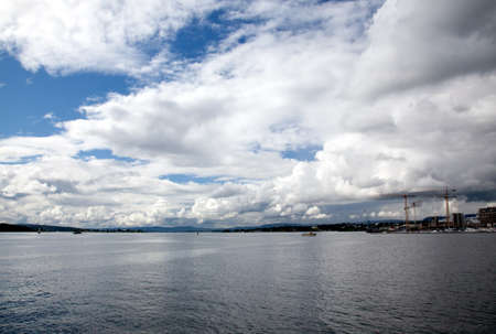 dramatic cloudscape in the harbor of Oslo Norwayの写真素材