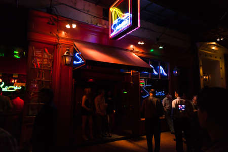 NEW ORLEANS, USA - APRIL 2: The Bourbon Streets in the French Quarter with crazy nightlife scene, and lined with bars and clubs, where is crowded with tourists and locals on Saturday night April 2, 2011.のeditorial素材