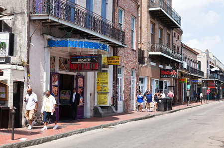 NEW ORLEANS, LOUISIANA - APRIL 3, 2011: The Bourbon Streets in the French Quarter lined with bars and clubs on April 3, 2011, where tourists and locals enjoyed on a sunny weekend in Spring.のeditorial素材