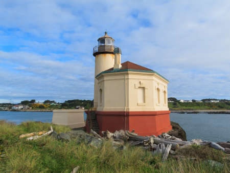Rocks, Blue Water and the Coquille River Lighthouse on the Picturesque Pacific Coast of Oregon.の写真素材